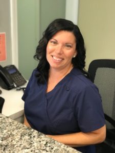 Nicole assists patients at the front desk of Fisher Pointe Dental in Grosse Pointe, Michigan.