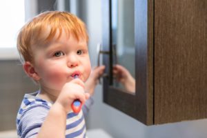 A toddler brushes his teeth. It's never too soon to teach young children about the importance of regular dental care.