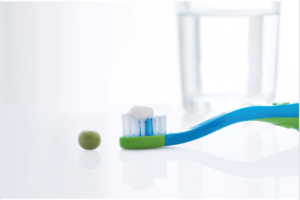 Fluoride-based toothpastes can be used for children ages 3 and older. A pea-sized amount of toothpaste should be used for toddlers, as shown in this image.